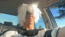 a person wearing a white wig and a black and white striped shirt