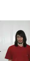 a man with long hair and glasses wearing a red t-shirt