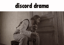 a black and white photo of a man sitting on a chair with the words discord drama above him