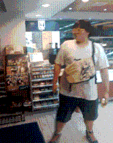 a man in a white shirt is standing in a store with a sign that says ' lx ' on it