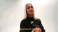 a woman wearing a black nike sweater is talking