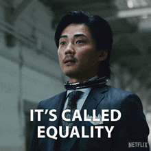 a man in a suit and tie says it 's called equality in white letters