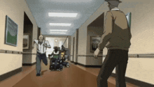 a man in a hat is standing in a hallway with a man in a wheelchair .
