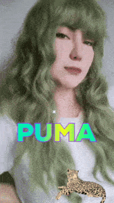 a woman with green hair has the word puma written on her face
