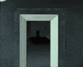 a doorway in a dark room with a light coming out of it