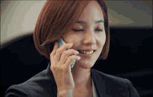 a woman talking on a cell phone with her eyes closed