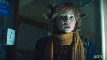 a young boy with antlers on his head and a netflix logo