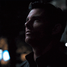a close up of a man 's face with his eyes closed