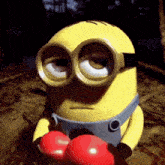 a yellow minion wearing boxing gloves with the letter s on them