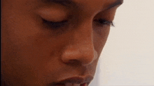 a close up of a young man 's face with his eyes closed .