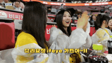 a group of women sitting in a stadium with a sign that says ifzip