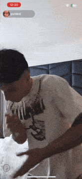 a phone screen shows a man wearing a t-shirt that says ' basketball '