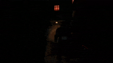 a person walking in a dark room with a sign that says ' united ' on it
