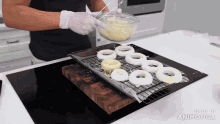 a person is making onion rings on a stove top with the words made in animatica on the bottom right