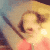a blurry picture of a person 's face with a red shirt on