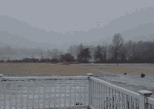 a person 's hand reaches out towards a snowy field