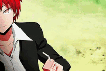 a man with red hair is holding a box of strawberry juice .