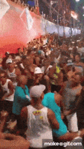 a crowd of people are gathered in a stadium with the words make a gif.com at the bottom of the screen