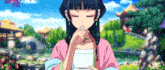 a girl in a pink shirt is eating something from a bowl