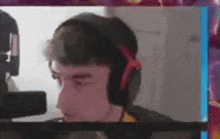a man wearing headphones is sitting in front of a microphone