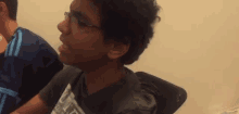 a young man wearing glasses and a black shirt that says ' ucsd ' on it