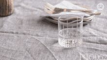 a glass of water sits on a table with a food52 logo in the corner