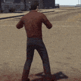a man in a red shirt and black pants is standing on the sidewalk
