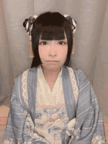 a woman wearing a blue and white dress with flowers on the sleeves