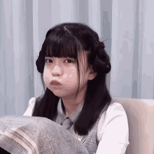 a girl with pigtails making a funny face with her mouth open