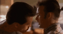 two men are looking into each other 's eyes and talking