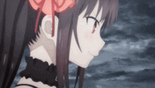 a close up of a girl with a red bow on her hair