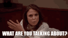 a woman in a white dress is asking what are you talking about .