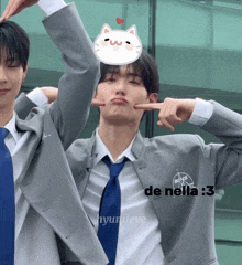 a man in a suit and tie has a cat on his head and says de nella 3