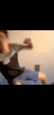 a blurry picture of a person laying on a bed with their arms outstretched