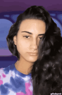 a gif of a woman with a purple background and the words gifsdayrol at the bottom