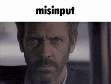 a close up of a man 's face with the word misinput written above him