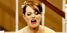 a woman is making a funny face with her mouth open .