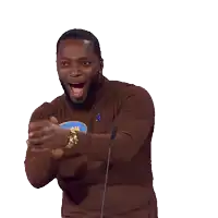 a man wearing a brown sweater with a blue sticker that says dellow