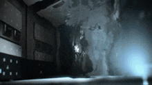 a dark room with a light coming out of the corner