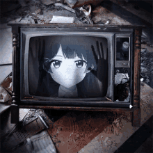an old television with a girl on the screen and a hand behind her