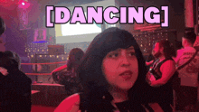 a woman in a club with the word dancing above her head