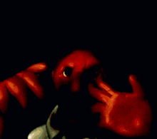 a close up of a bloody face with a white shirt on