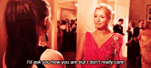two women are standing next to each other in a room and one of them is talking to the other .