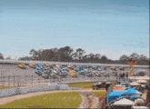 a row of race cars are lined up on a race track