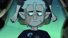 a cartoon character with a scar on his face is sitting in a chair with a person 's feet behind him .