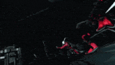 a woman in a red cape is holding a sword in her hand
