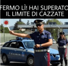 a police officer is holding a sign in front of a blue car