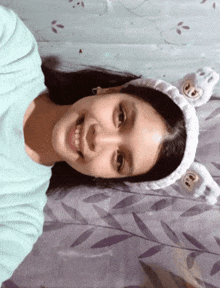 a girl wearing a headband with bunny ears on it
