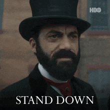 a man with a beard wearing a top hat and a hbo logo