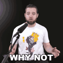 a man with a beard is singing into a microphone with the words why not behind him